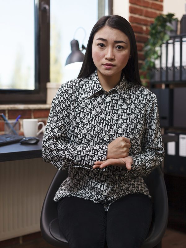 Young productive asian businesswoman explaining urgent business financial matter while making gesture with hands. Marketing company worker looking at camera and hand gesturing.